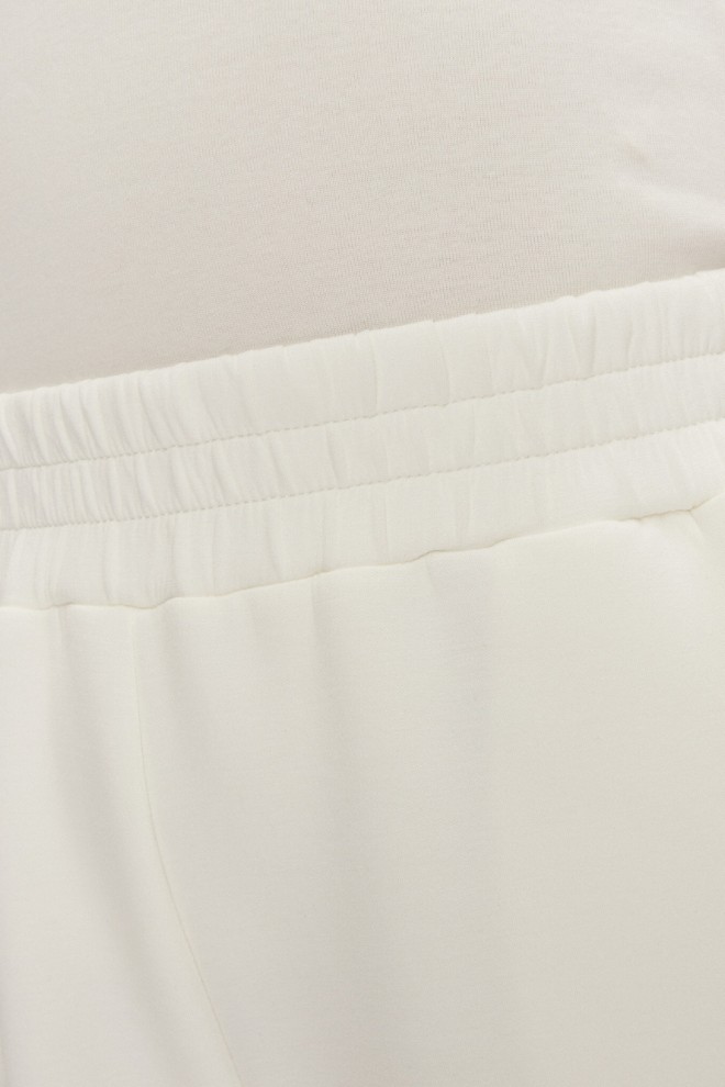 GUESS Dresowe damskie spodnie w kolorze ecru Cecilia Scuba